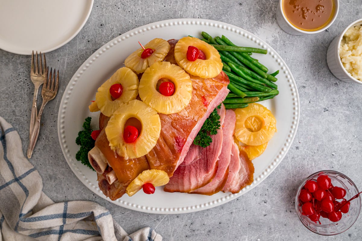 Holiday ham and green beans on a platter.