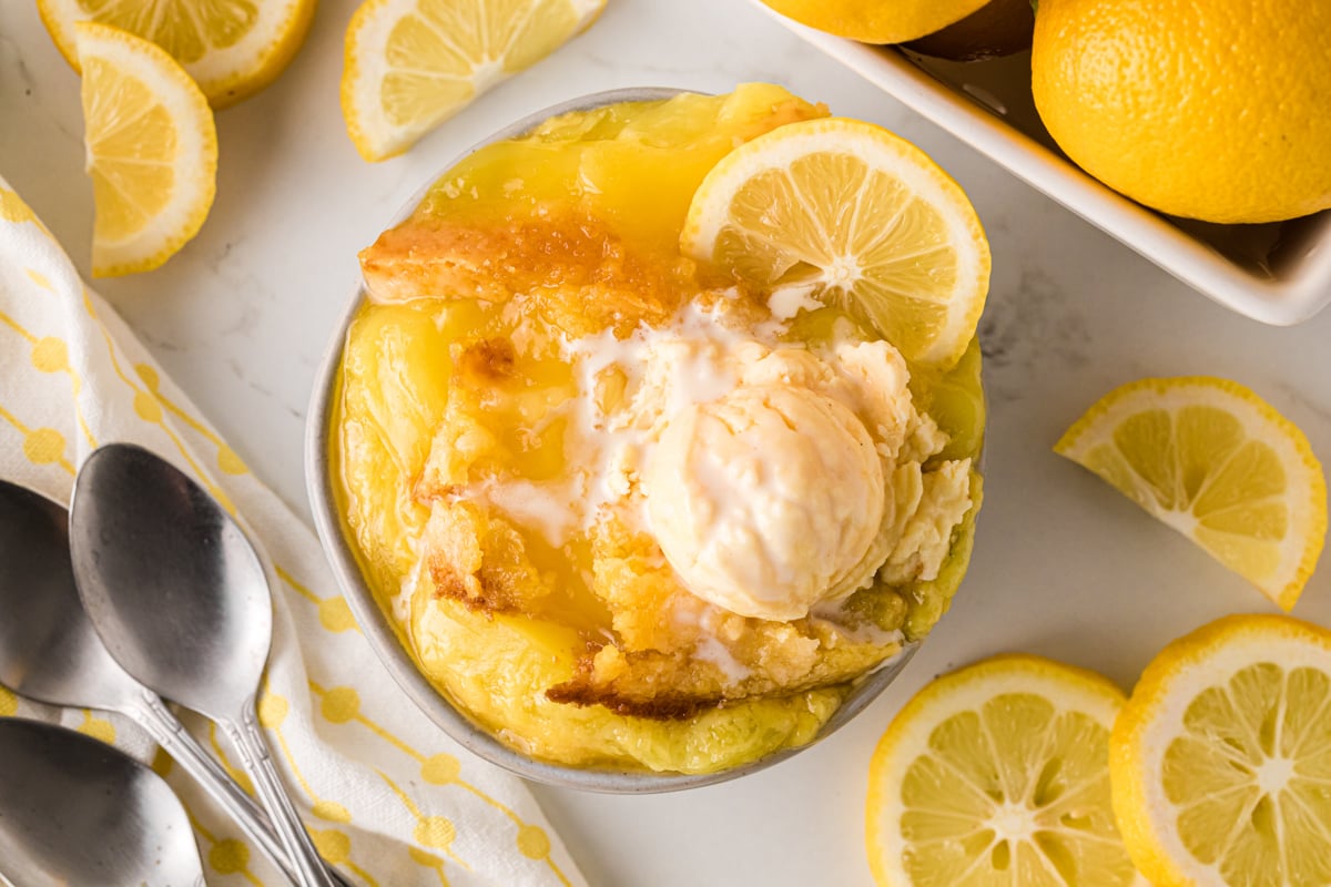 A serving of lemon dump cake with a scoop of ice cream.