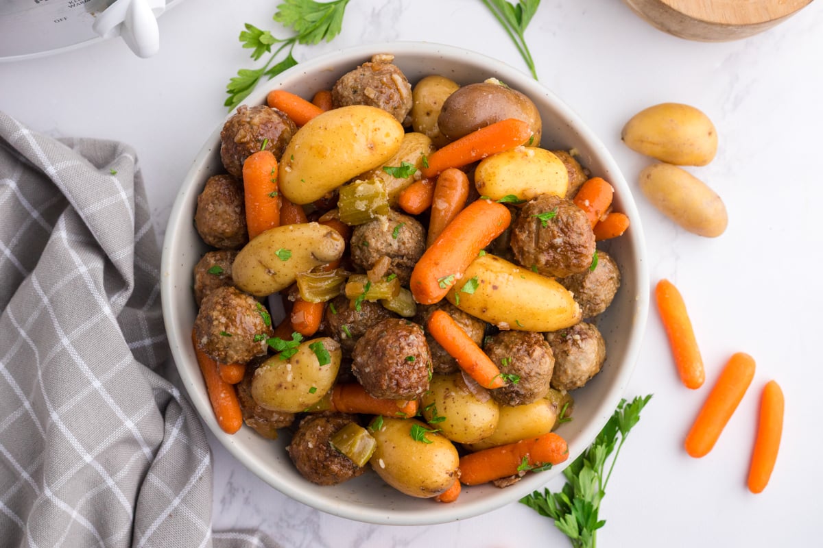A serving of meatball pot roast in a white bowl.