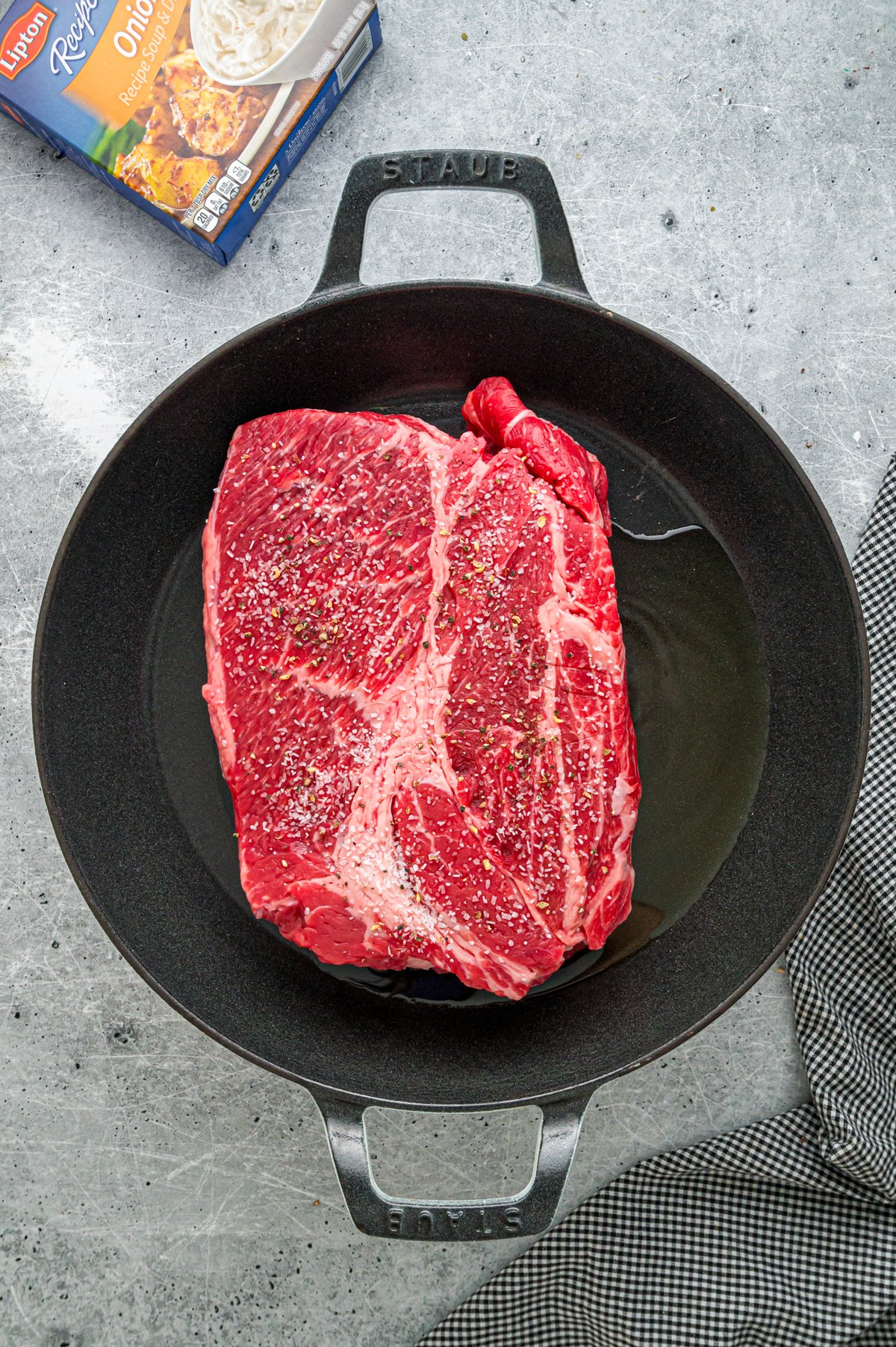 Searing chuck roast in a skillet.