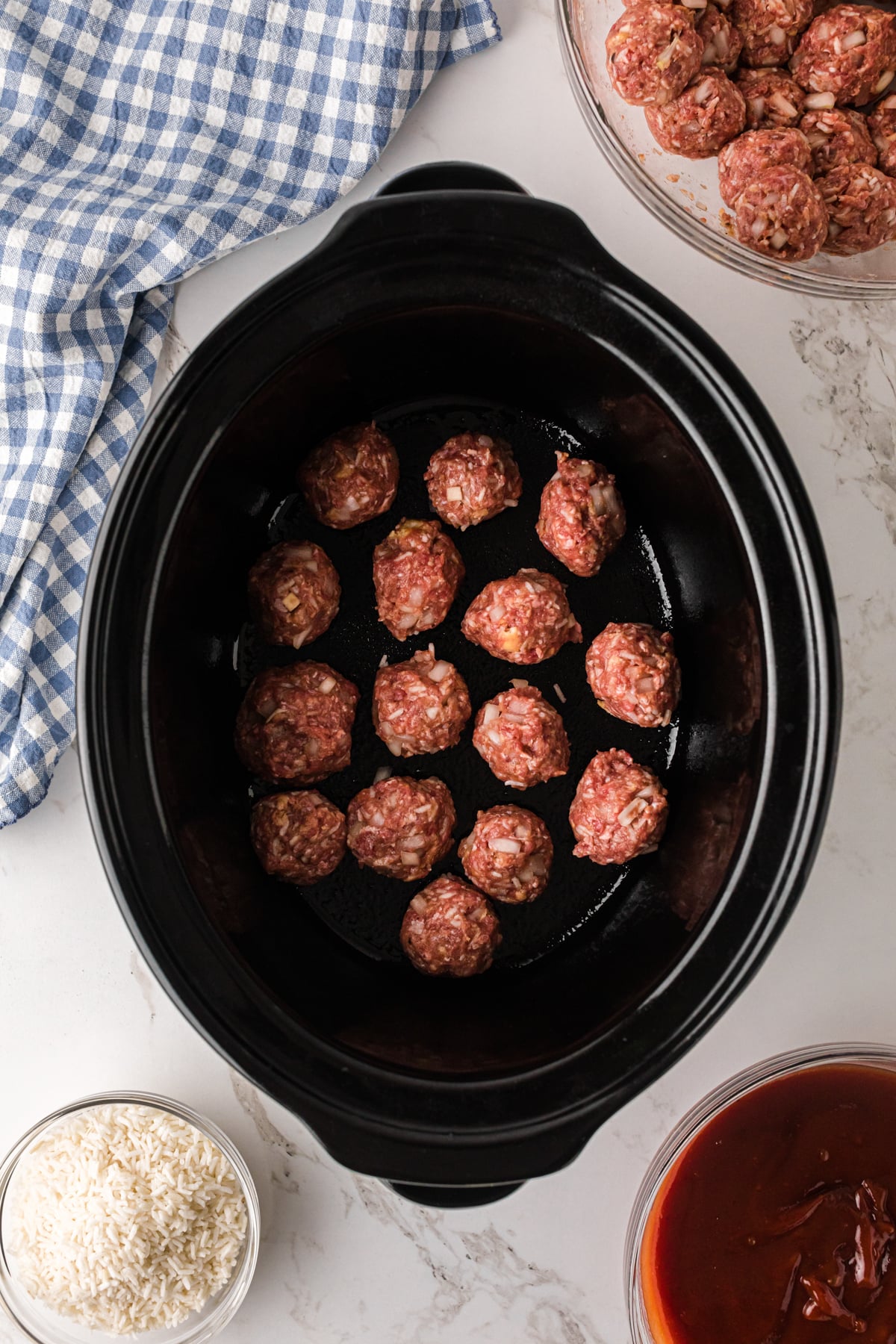 Formed meatballs in a crockpot.