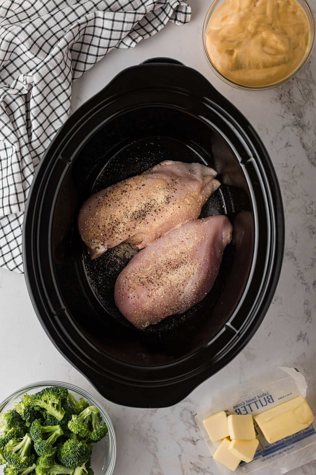 Seasoned chicken breasts in a slow cooker.