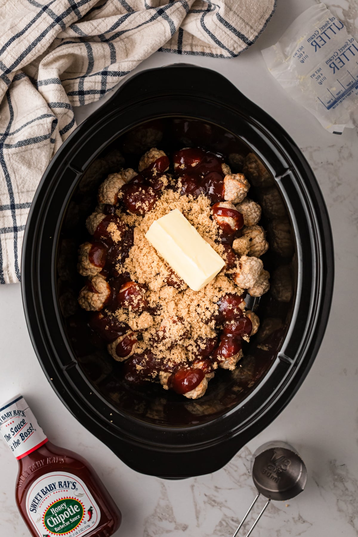 Meatballs, bbq sauce, butter, and brown sugar in a crockpot.