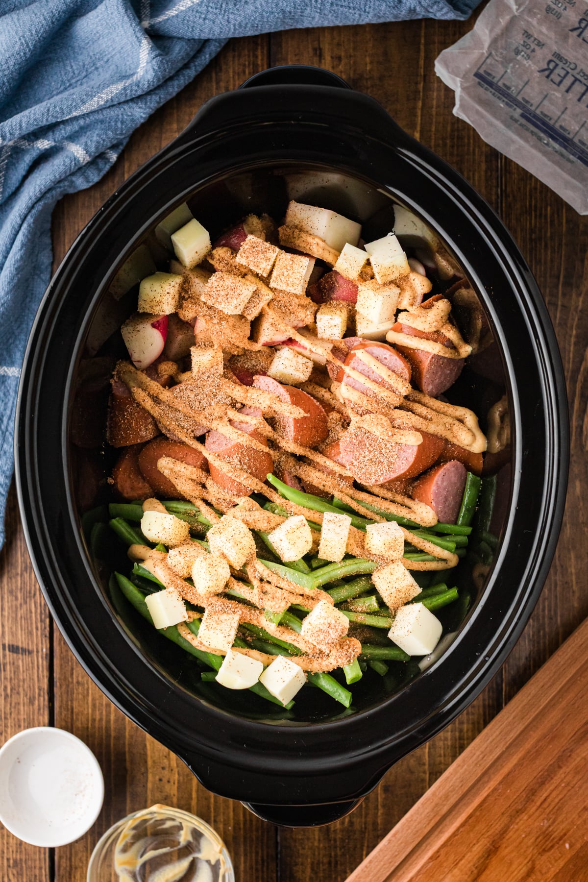 Ingredients for kielbasa dinner in a slow cooker.