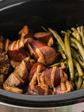 Kielbasa, green beans, and potatoes in a crockpot after cooking.