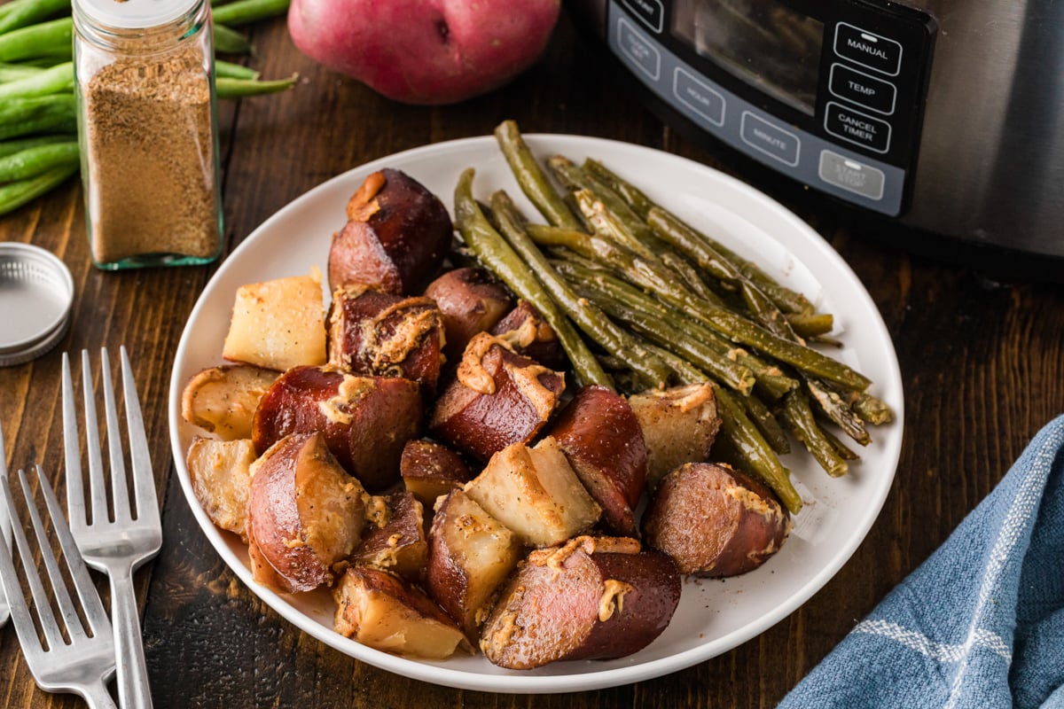 Kielbasa dinner on a white plate.