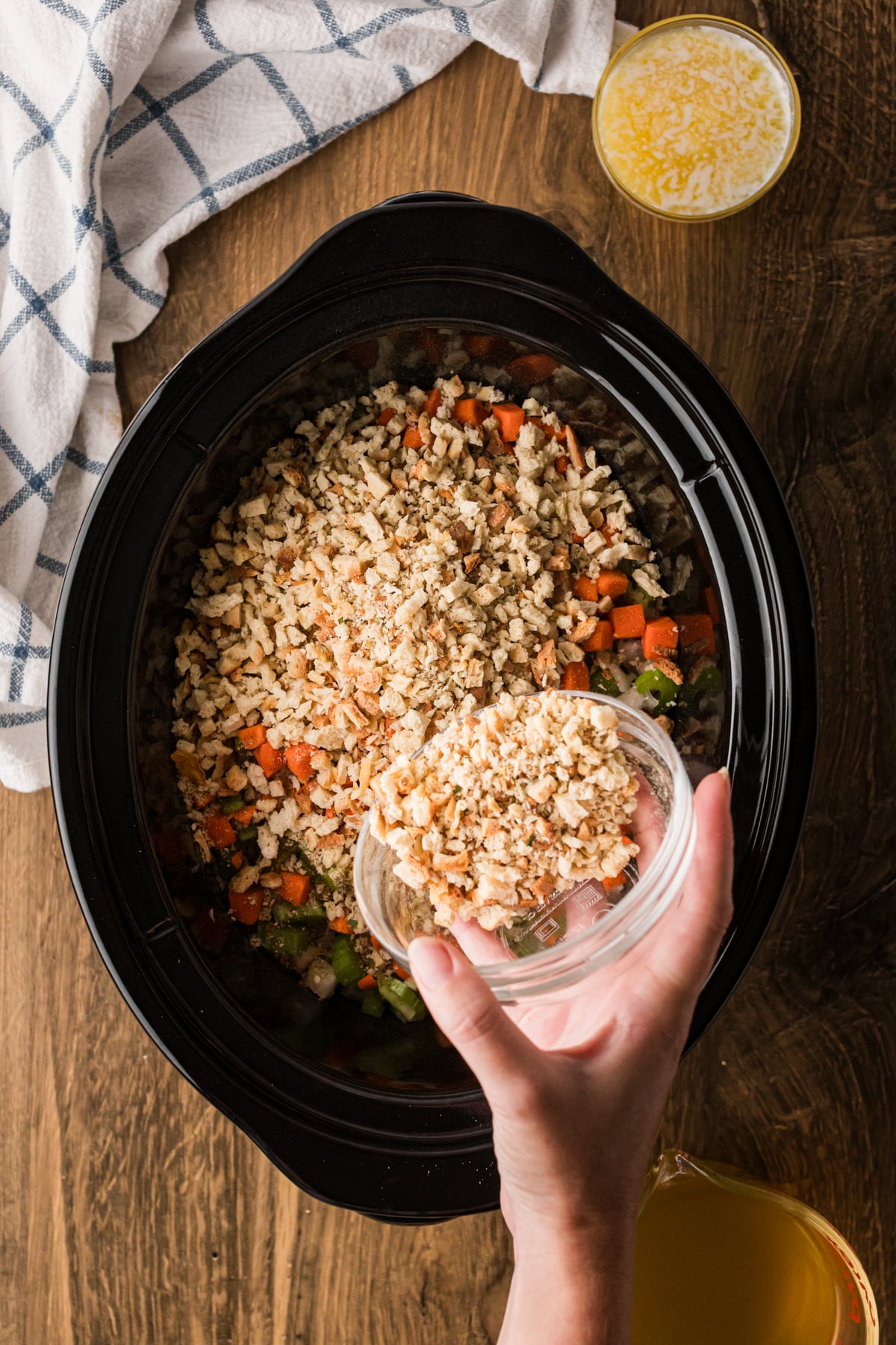 Pouring stuffing mix into a crockpot.