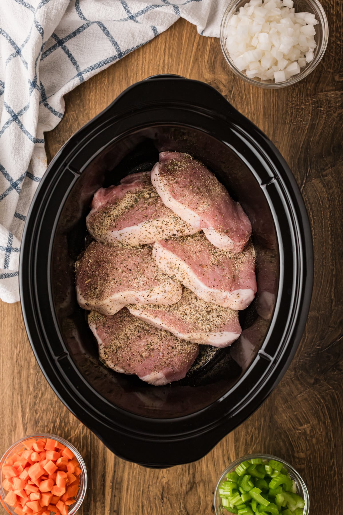 Seasoned pork chops in a slow cooker.