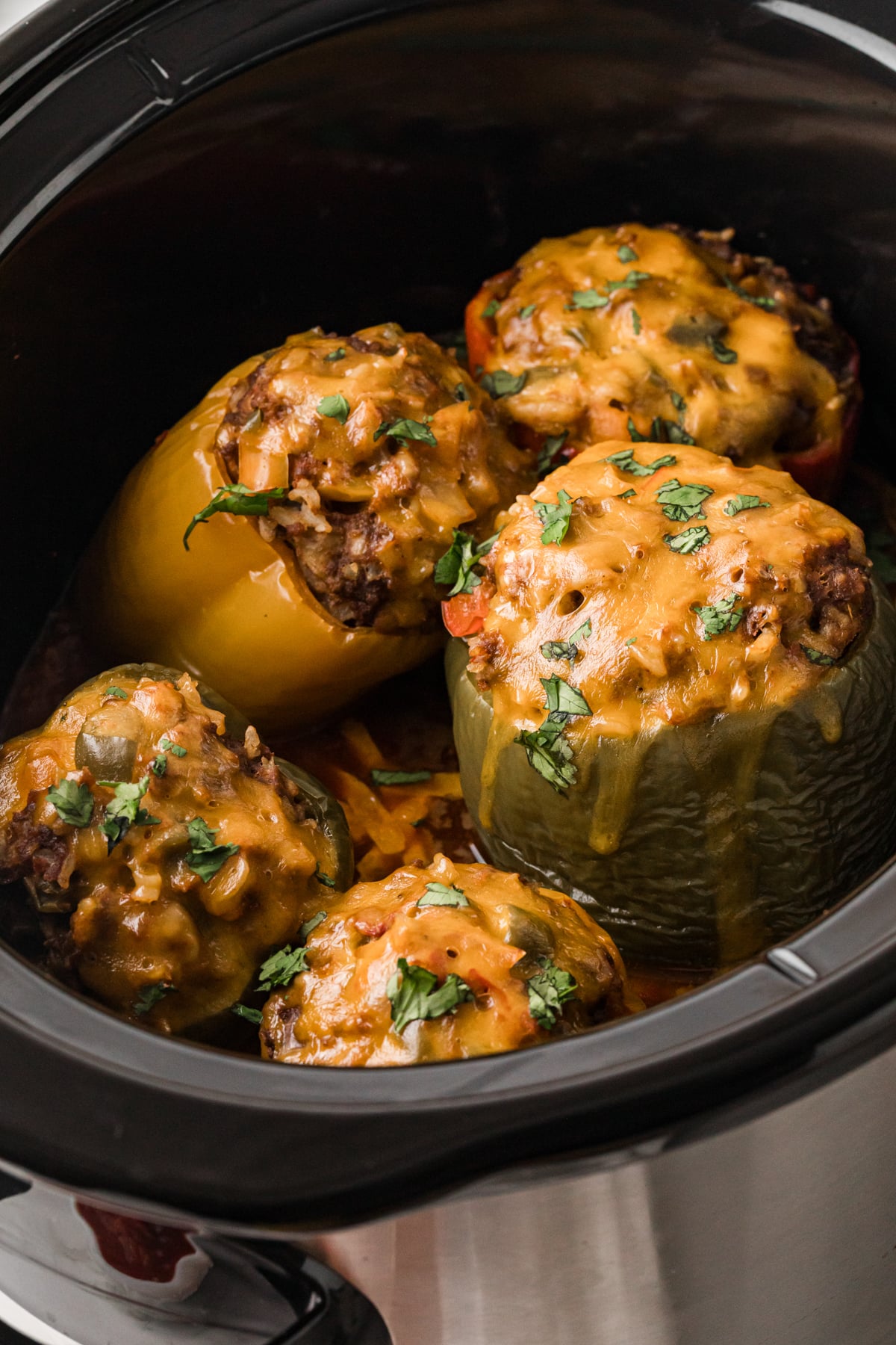 Taco stuffed peppers in a crockpot after cooking.