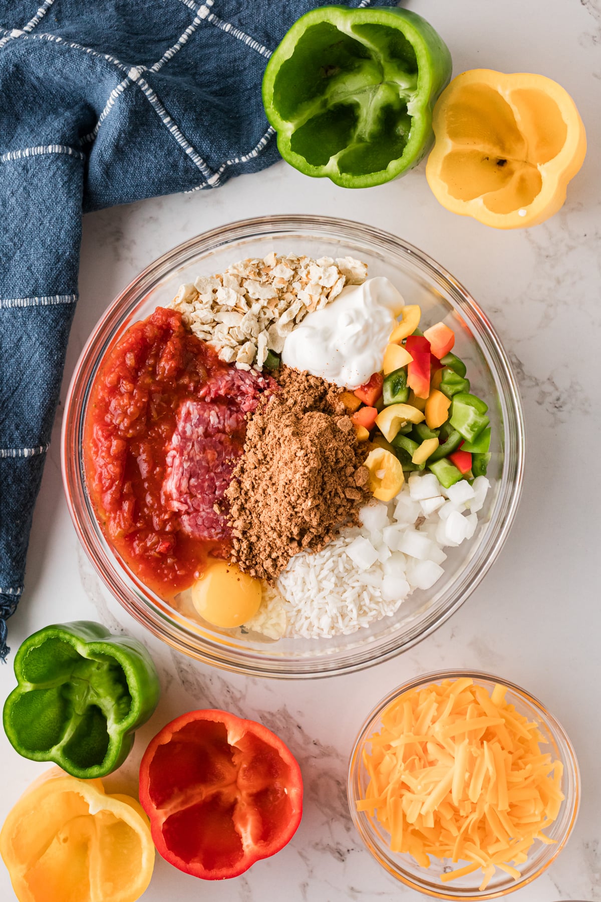 Ingredients for stuffed pepper filling in a glass bowl.