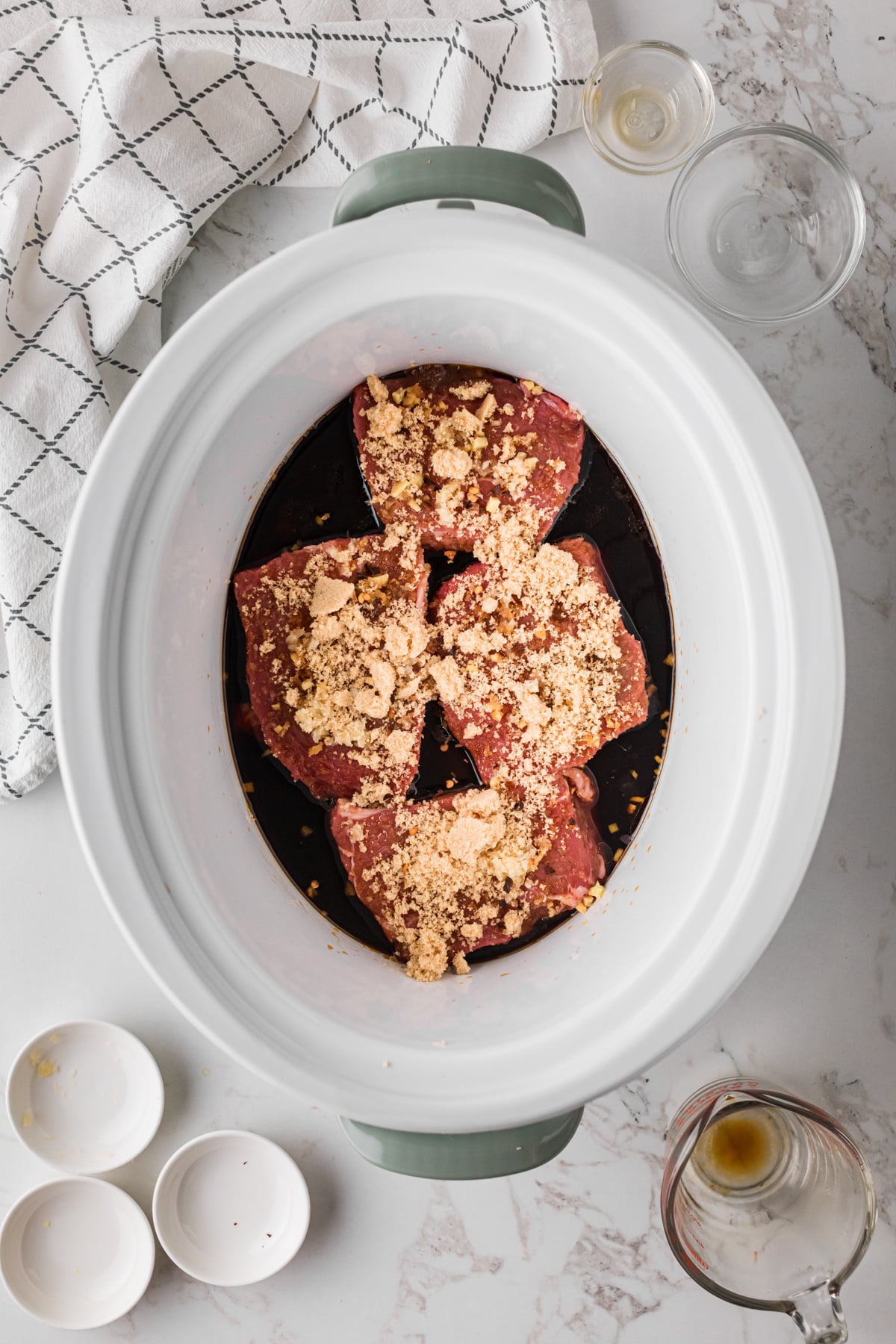 Seasoned steaks with soy sauce and sesame oil in a slow cooker.