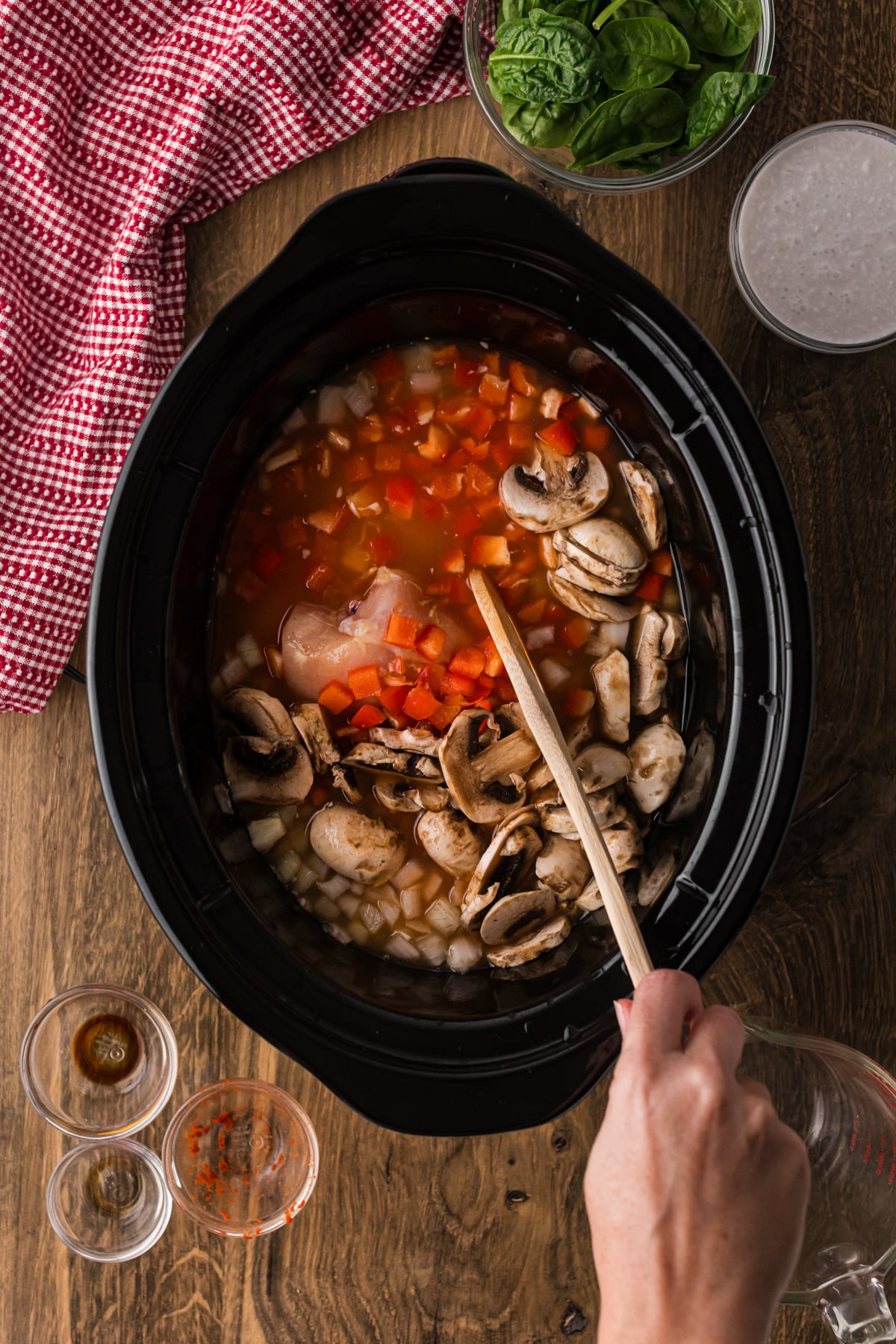 Stirring soup ingredients in a crockpot.