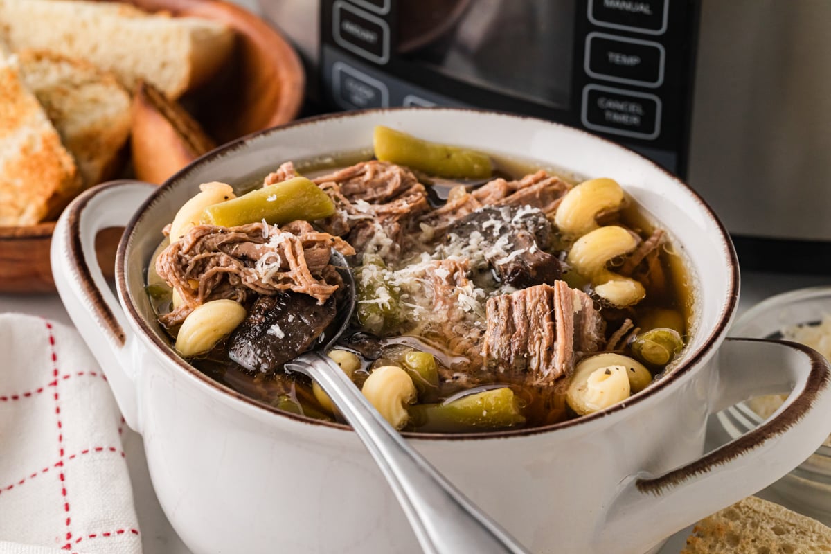 French dip soup in a bowl with a spoon in it.