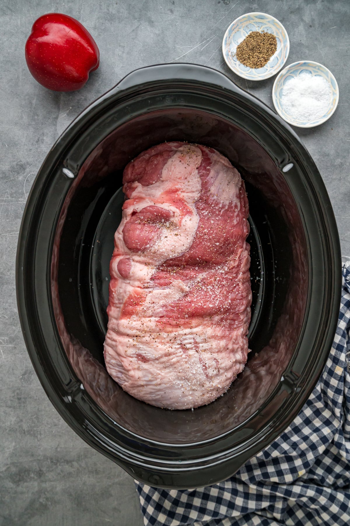 Raw pork loin in a crockpot.