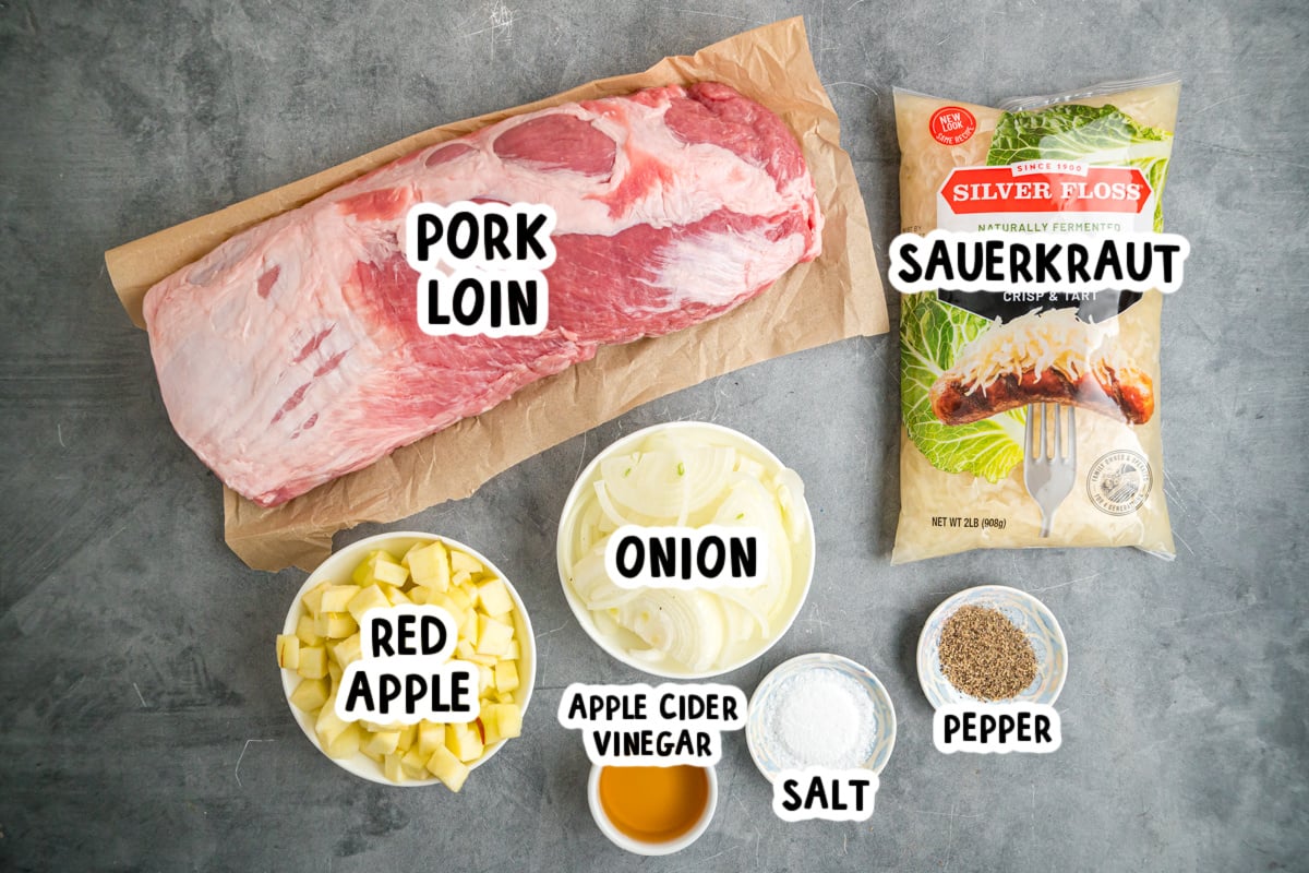 Ingredients for making crockpot pork and sauerkraut on a table.