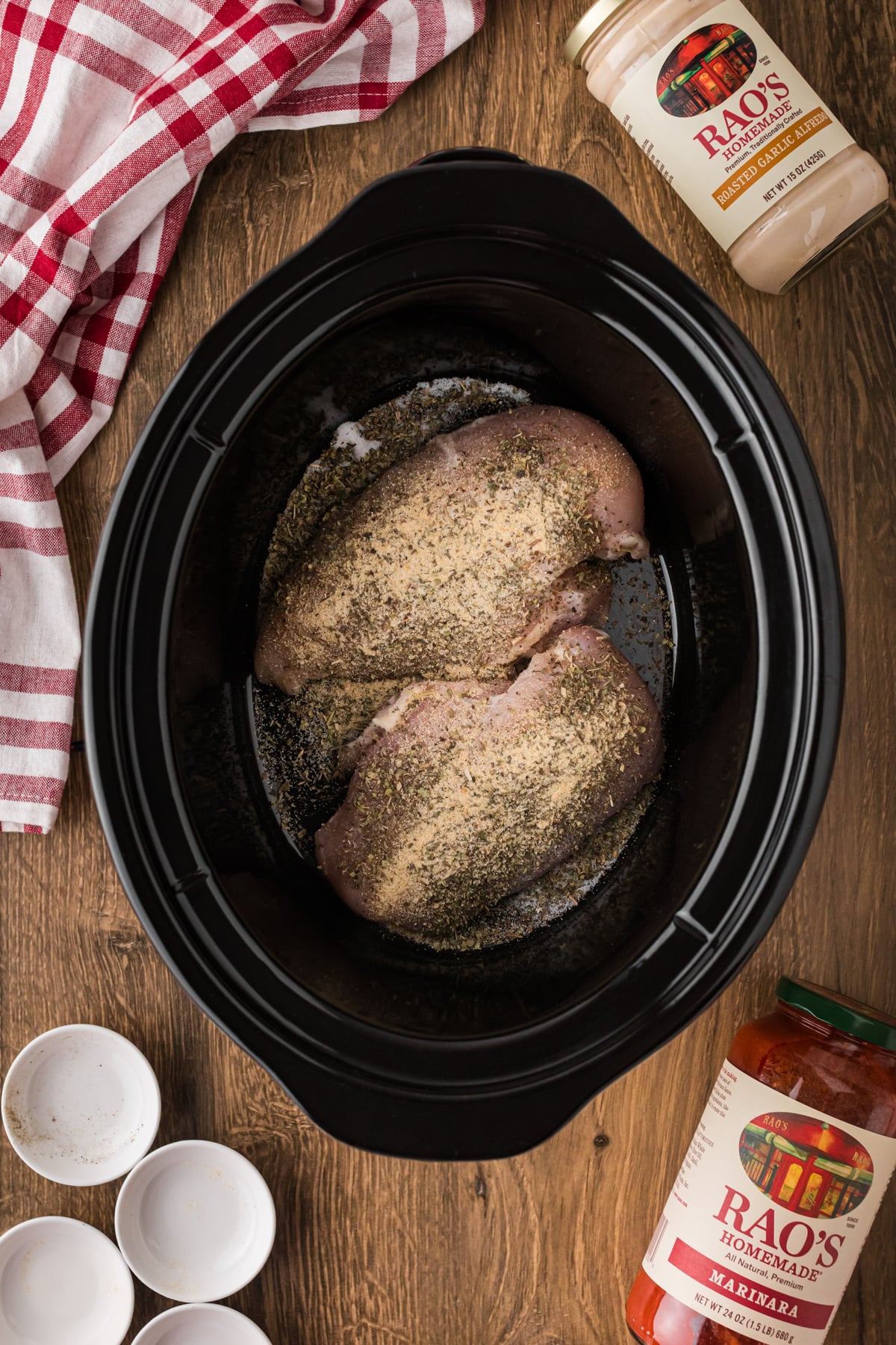 Seasoned chicken breasts in a crockpot.