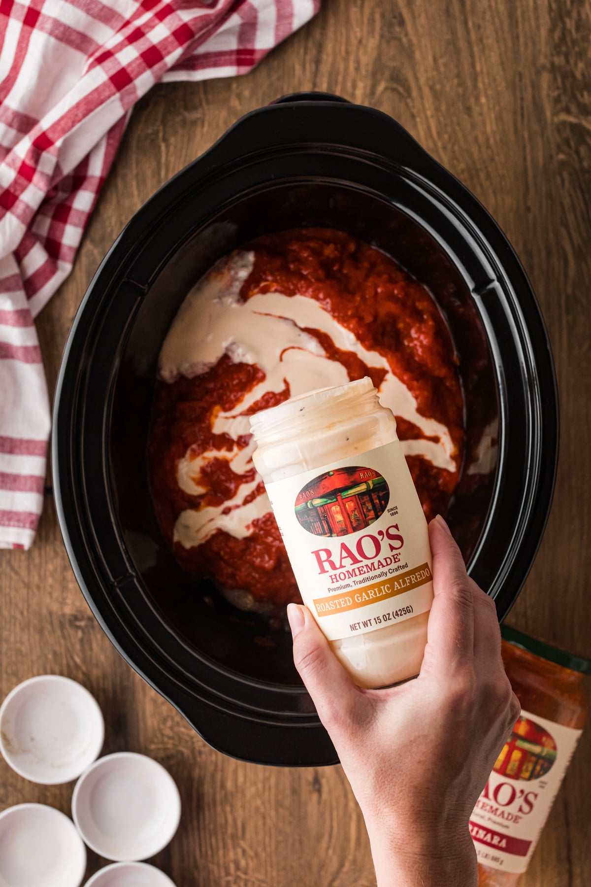 Pouring alreado sauce into a crockpot.