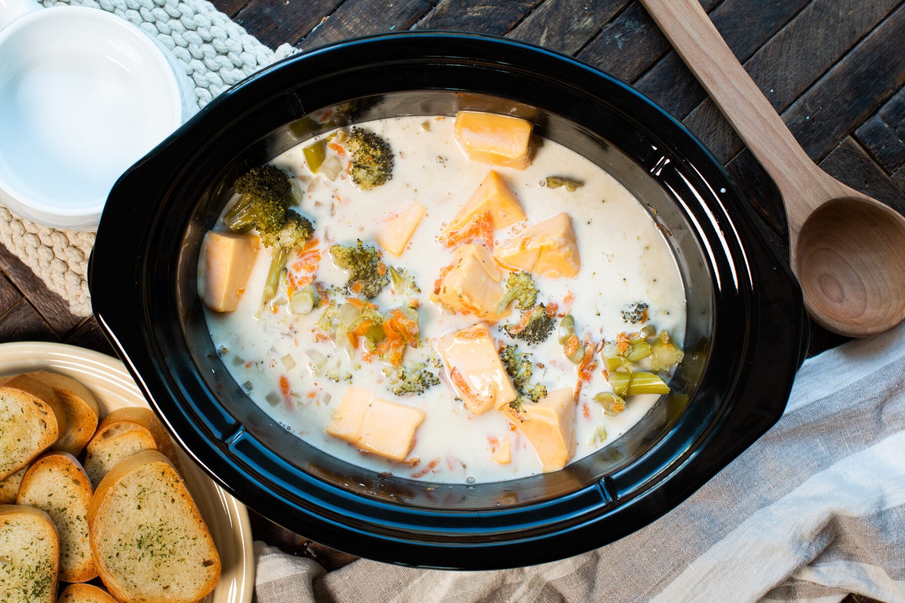 all the ingredients done cooking for broccoli cheese soup in a slow cooker.