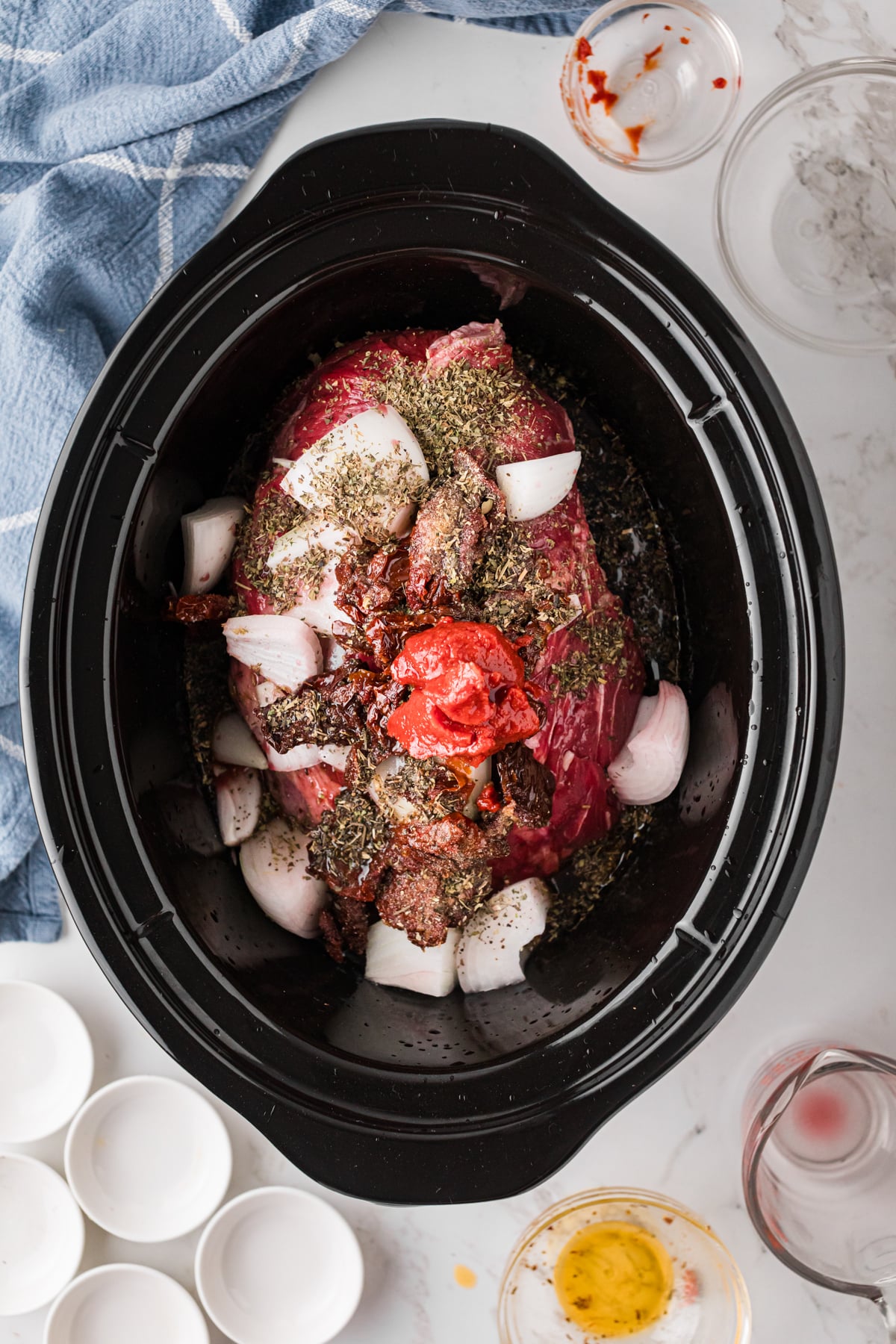 Ingredients for marry me pot roast in a crockpot before cooking.