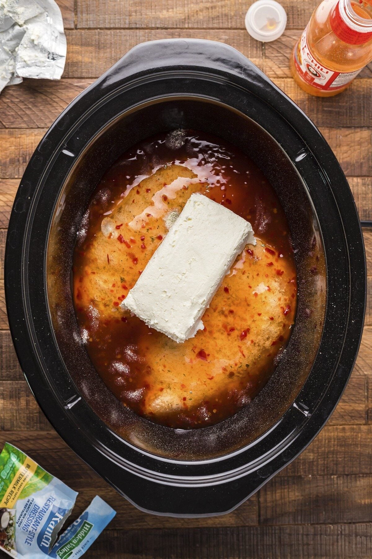 chicken, ranch mix, sweet chili sauce and cream cheese in a slow cooker for sweet chili chicken.