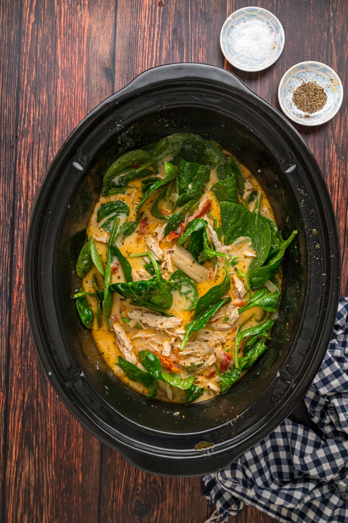 Heavy cream, spinach, and parmesan cooked into soup in a crockpot.