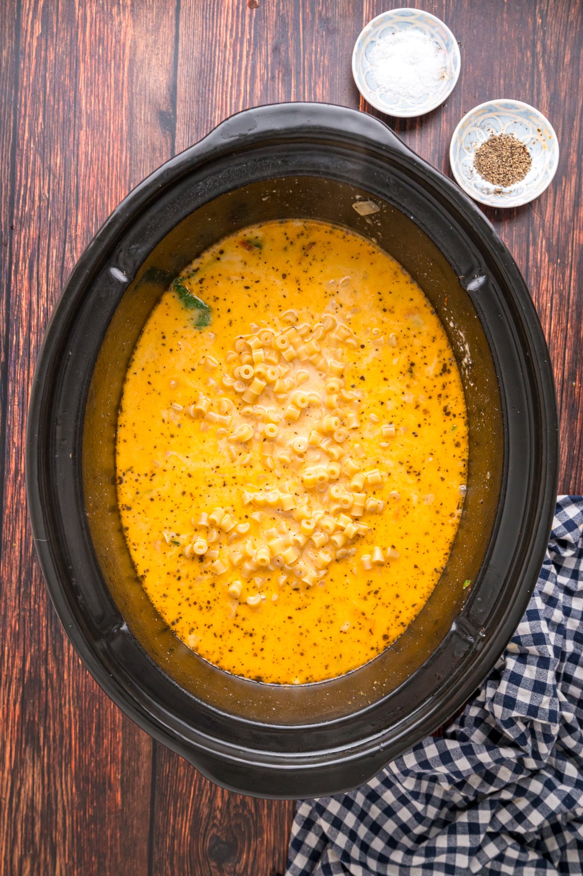 Ditalini pasta added to soup in a crockpot.