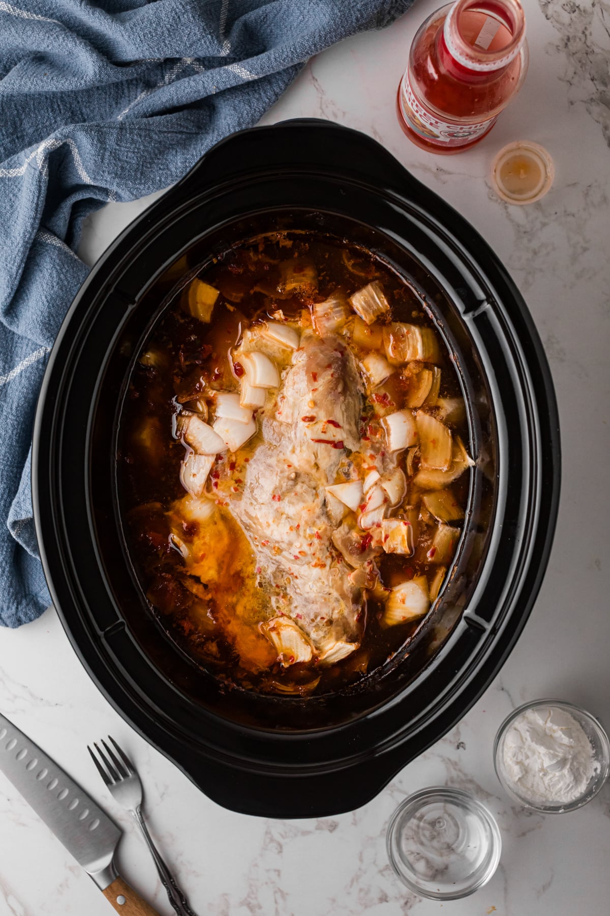 Cooked pork loin in a crockpot.