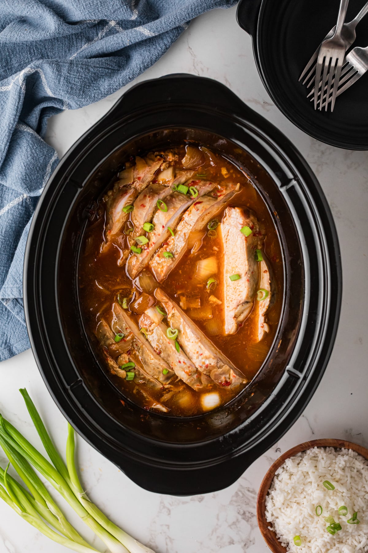 Sliced sweet chili pork in a slow cooker.