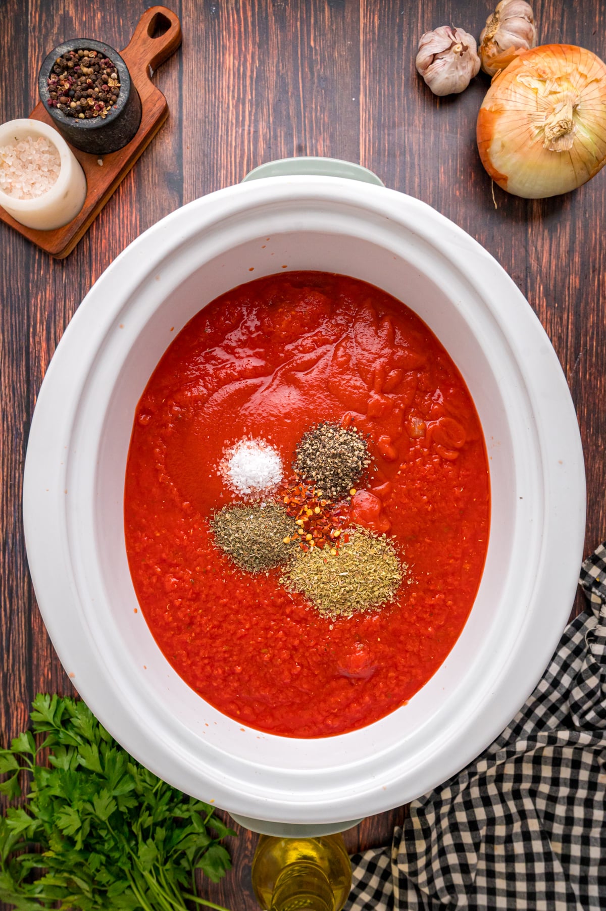 Seasonings added to sauce and meat mixture in a crockpot.
